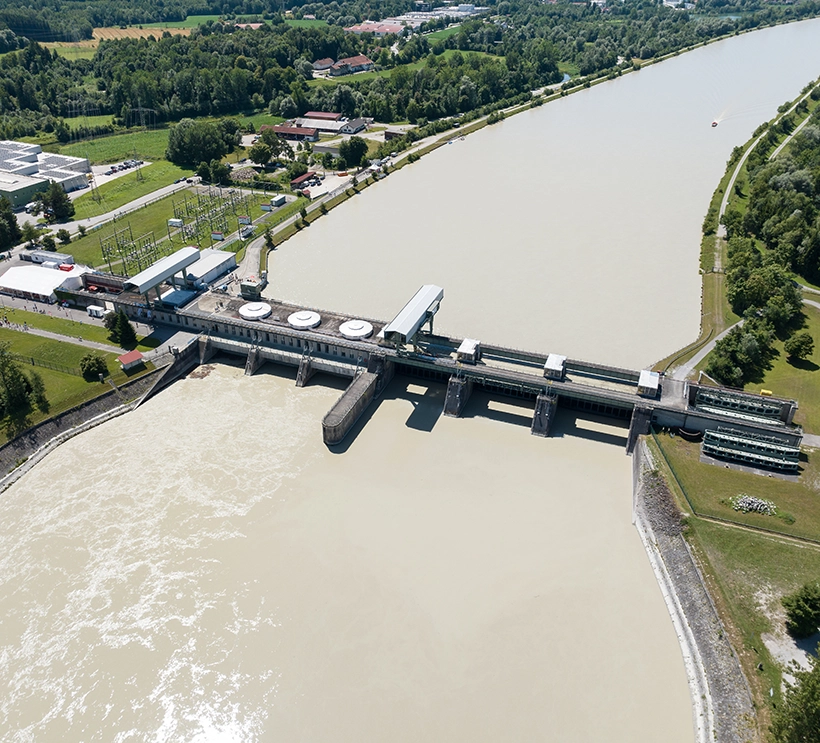 Das Kraftwerk Rosenheim zeigt sich bei strahlendem Sonnenschein aus der Vogelperspektive.